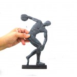 A discus thrower is depicted about to release his throw