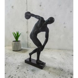 A discus thrower is depicted about to release his throw,  bronze  sculpture 
