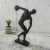 A discus thrower is depicted about to release his throw,  bronze  sculpture 